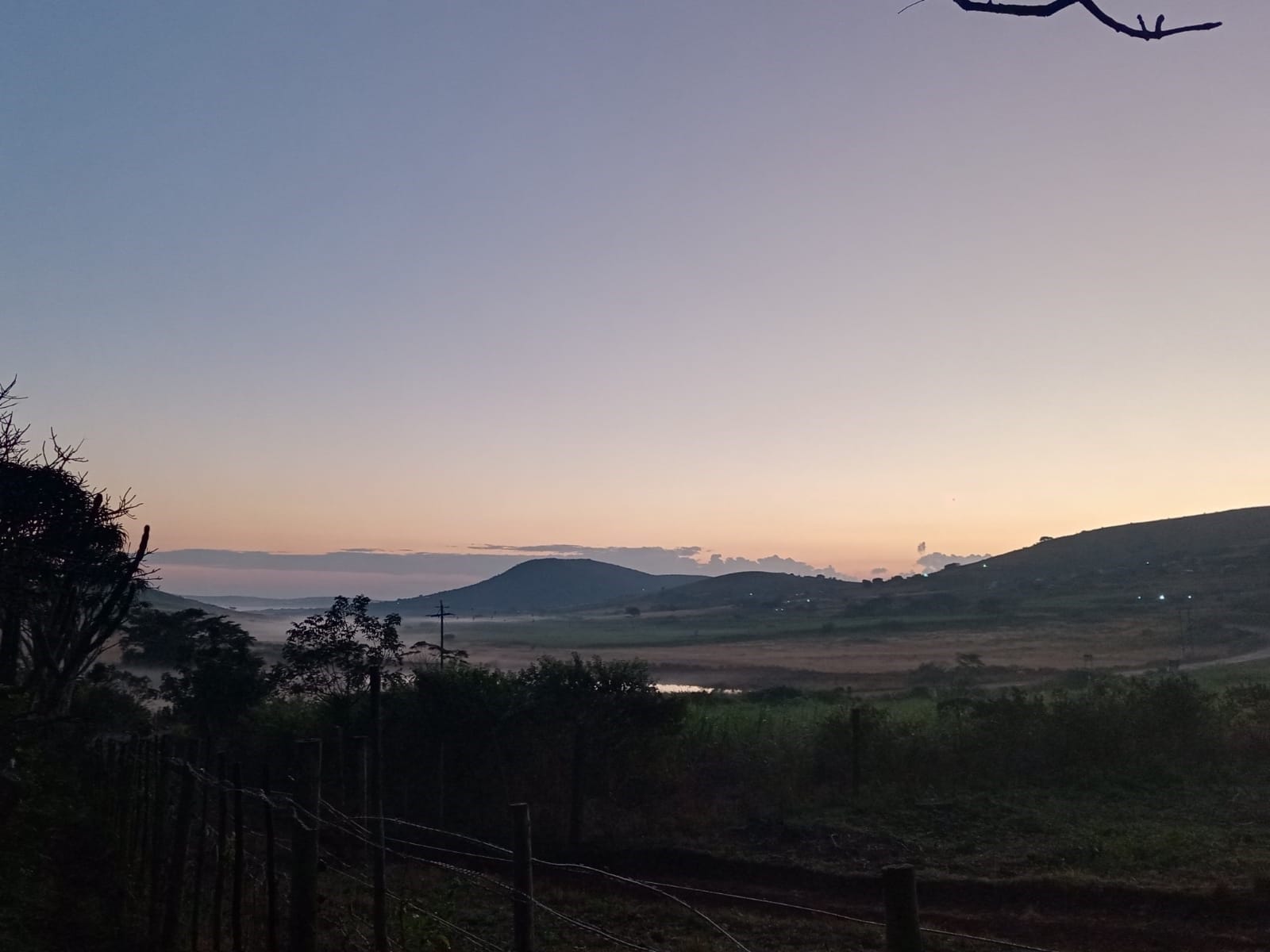 Misty sunrise view over the valleys near Hluhluwe-iMfolozi Park, KwaZulu-Natal — the landscape Ethlathini is part of